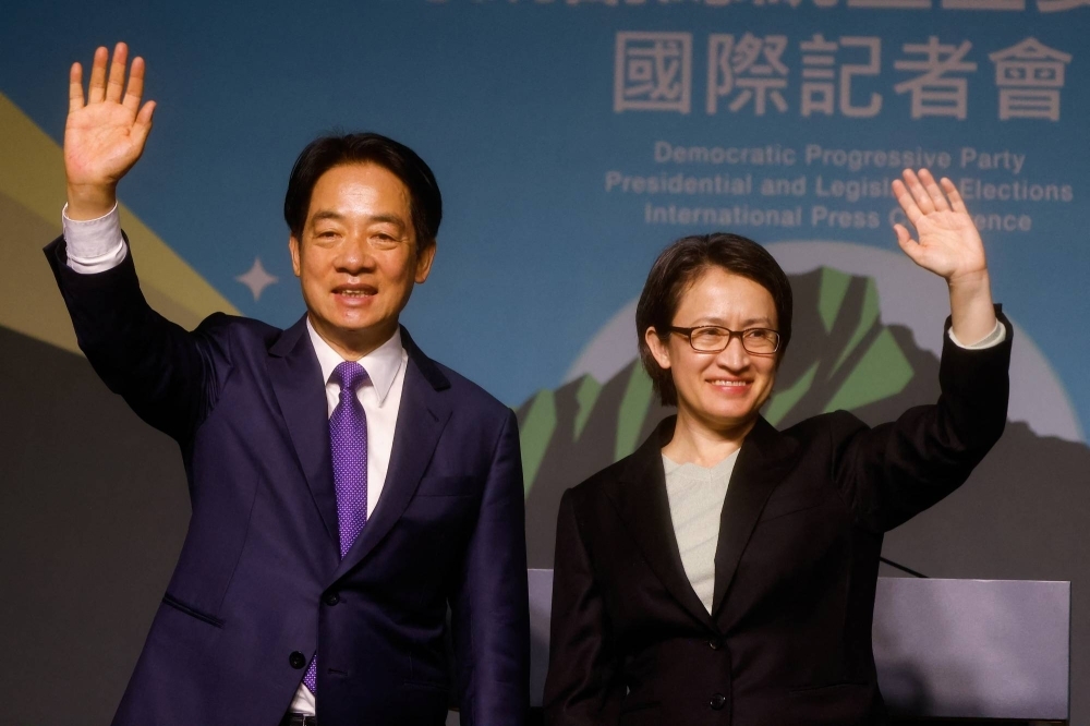 Taiwan President-elect Lai Ching-te, of Democratic Progressive Party's (DPP), and his running mate, Hsiao Bi-khim, wave as they hold a news conference, following their victory in  presidential elections, in Taipei, on Saturday.
