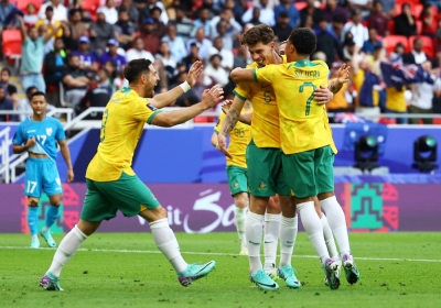 Australian players celebrate the team's second goal in their win over India on Saturday at the Asian Cup in Qatar. 
