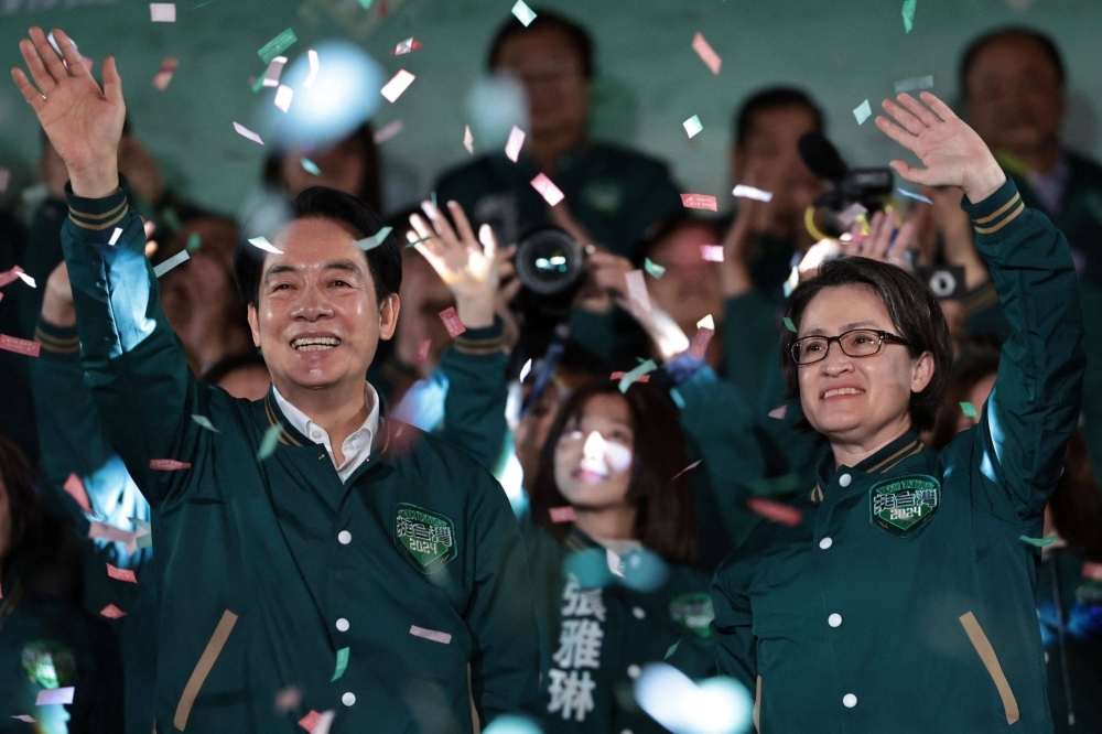 Taiwan President-elect Lai Ching-te and his running mate, Hsiao Bi-khim, attend a rally outside the headquarters of the Democratic Progressive Party in Taipei on Saturday night after winning the presidential election. 