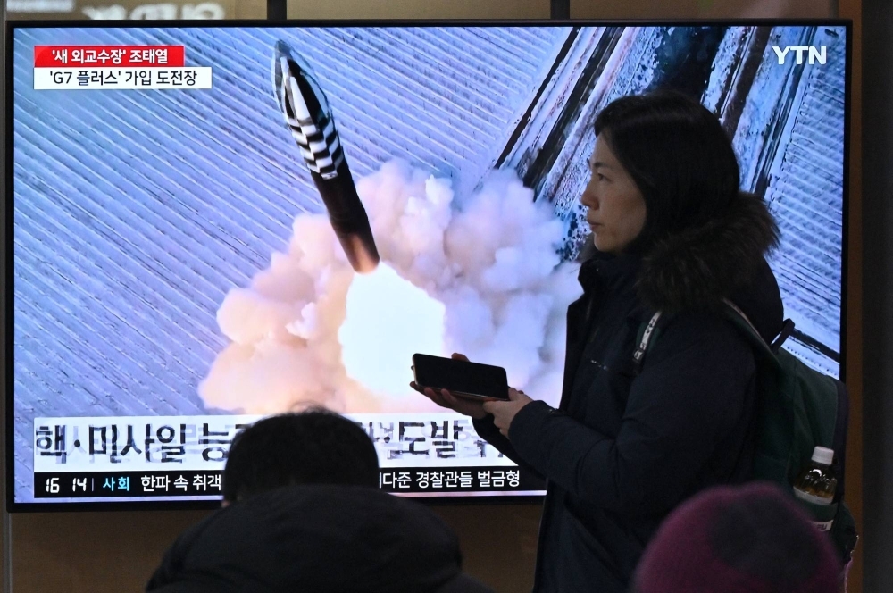 People watch a television screen showing  file footage of a North Korean missile test, at the main railway station in Seoul on Sunday.