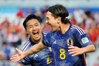 Japan midfielder Takumi Minamino (8) celebrates after scoring his team's first goal during the team's win over Vietnam on Sunday at the Asian Cup in Doha. 