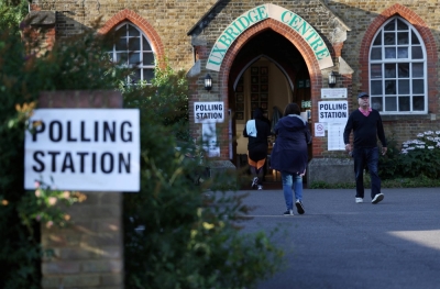 People walk outside a polling station in Uxbridge, Britain, on July 20.