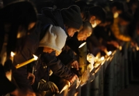 People light candles and offer prayers during an event at a park in Kobe on Wednesday, the 29th anniversary of the Great Hanshin Earthquake. | Kyodo