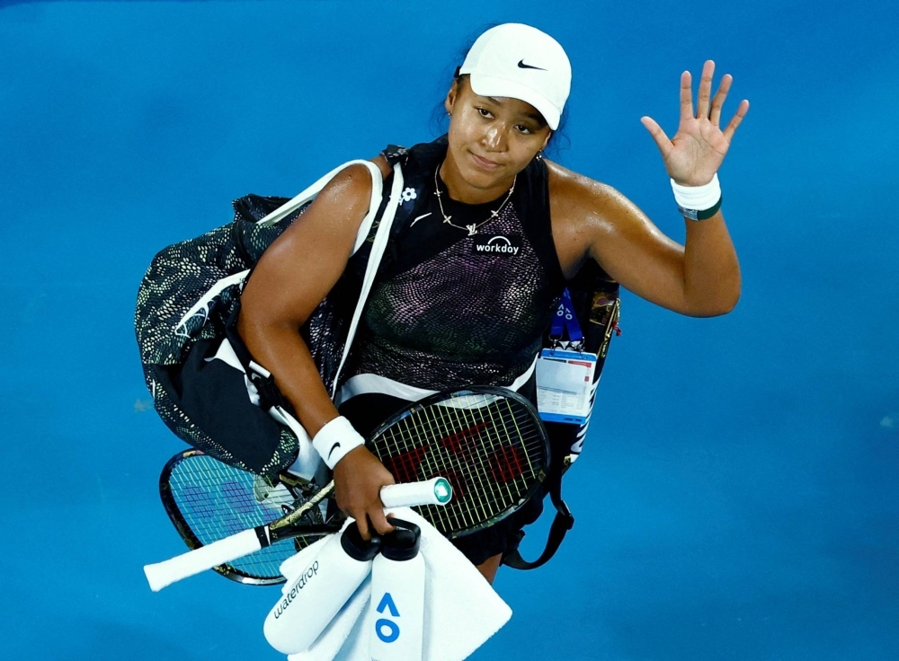 Naomi Osaka waves to the Australian Open crowd after losing her first round match on Monday in Melbourne. 