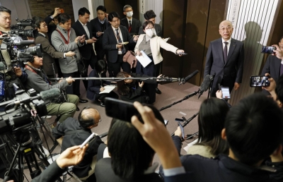 Daihatsu President Soichiro Okudaira speaks to reporters at the transport ministry on Tuesday.