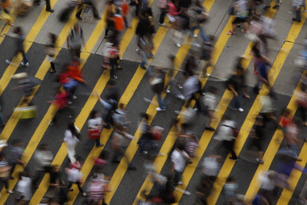 People cross a street in the Mong Kok district in Hong Kong in 2011.