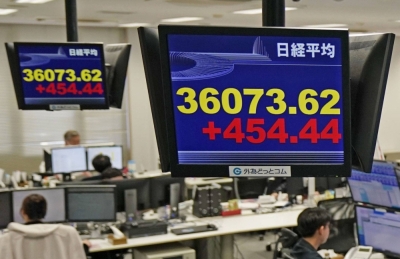 A monitor in Tokyo shows the Nikkei stock average rising above 36,000 on Wednesday.