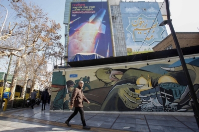 A large billboard depicting an Iranian missile with a phrase in Persian that reads "prepare your coffins" on the side of a building in Tehran on Tuesday