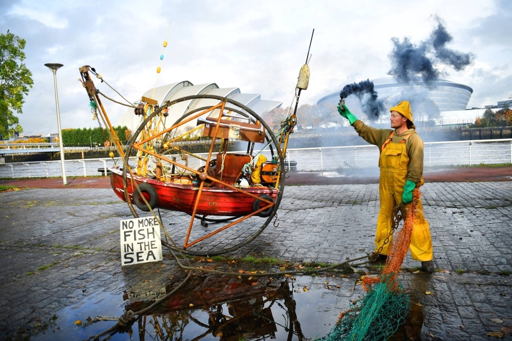 And Ocean Rebellion activist protests against bottom trawling during a demonstration ahead of the COP26 summit in Glasgow in 2021. 