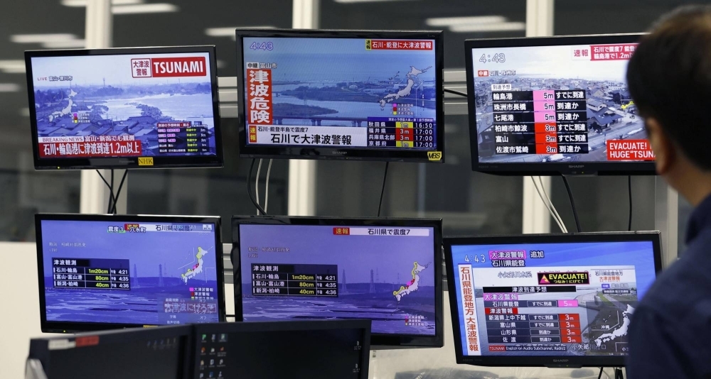 TV screens in Osaka show news of a large earthquake hitting a wide area of the Sea of Japan coast in central Japan and subsequent tsunami warnings in the affected regions on Jan. 1.