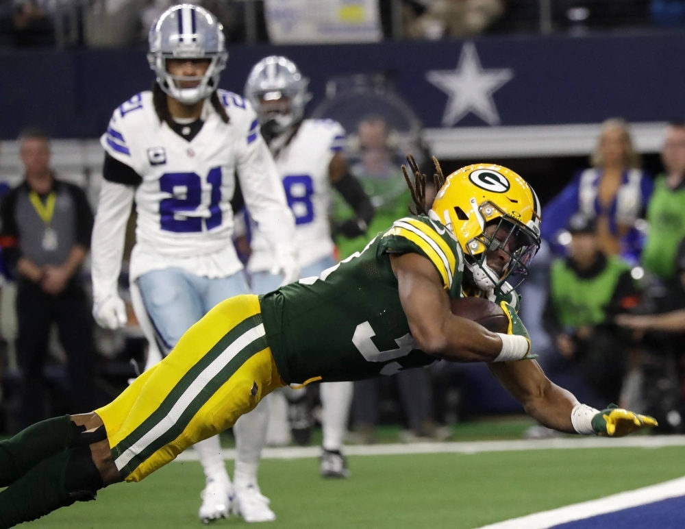 Green Bay Packers running back Aaron Jones dives for a touchdown against the Dallas Cowboys in a 2024 NFC wild card game at AT&T Stadium in Arlington, Texas, on Jan. 14.

