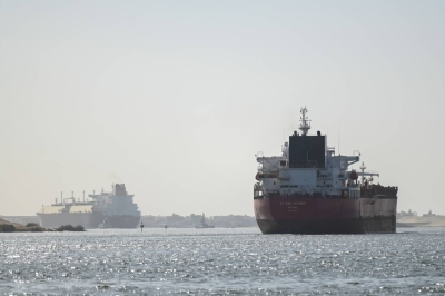 A ship transits the Suez Canal toward the Red Sea on Jan. 10. Insurance costs for ships whose seafarers who do brave the waterway have shot up tenfold, including a large increase since the airstrikes.