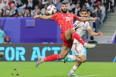 Palestine forward Shehab Qunbar jumps to receive the ball during his team's AFC Asian Cup Group C match against the United Arab Emirates in Al-Wakrah, south of Doha, on Thursday.