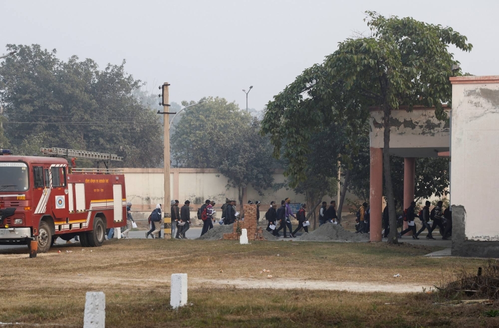 Skilled workers walk to a building for a skill test at a Haryana state government recruitment drive to send workers to Israel, at Maharshi Dayanand University in Rohtak, India, on Wednesday.