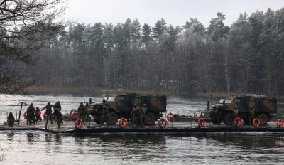 Polish military vehicles are transported during NATO exercises in Klusy, Poland, in November 2022. 