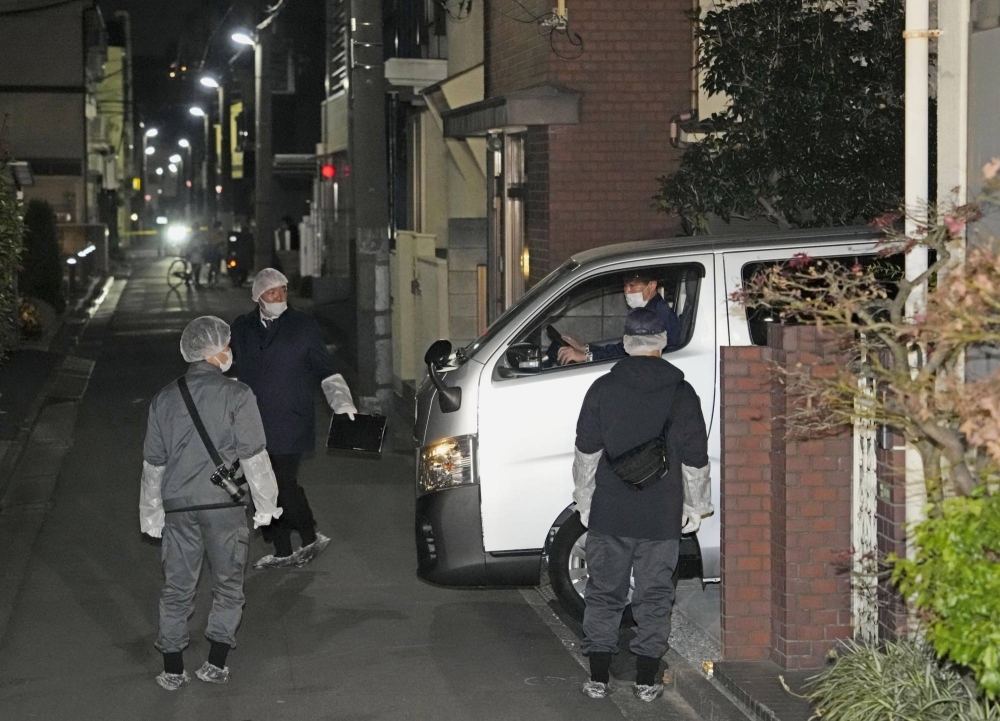 Police investigators conduct an on-site inspection Thursday at a house in Tokyo's Adachi Ward where two bodies had been found.