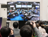 A screen shows JAXA officials in the mission control room at the space agency's campus in Sagamihara, Kanagawa Prefecture, on Saturday.  | Kyodo 