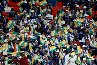 India supporters wave the country's flag before the start of the national soccer team's Asian Cup game against Uzbekistan on Thursday in Al-Rayyan, Qatar. 