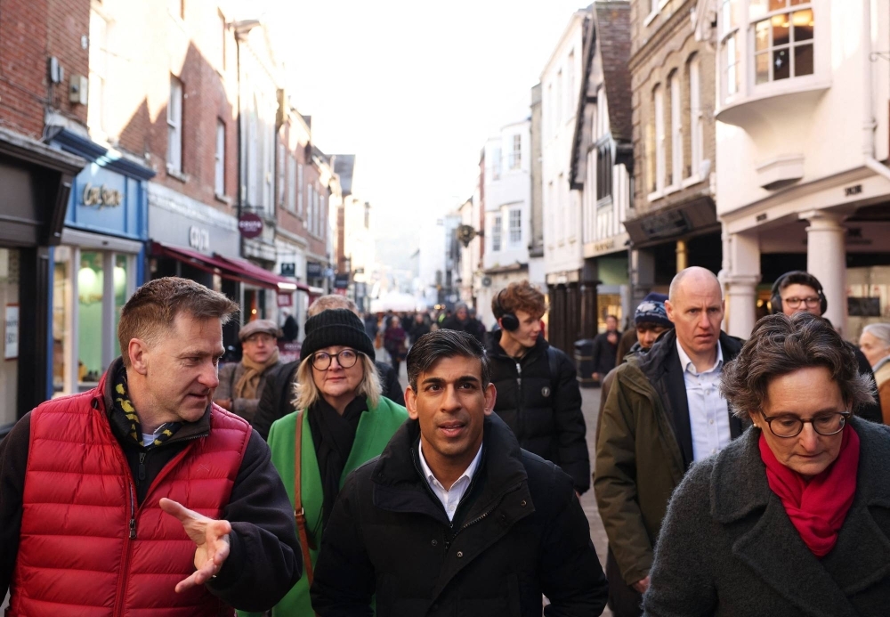 British Prime Minister Rishi Sunak meets with local residents during a walkabout with Conservative MPs in Winchester, England, on Friday. 