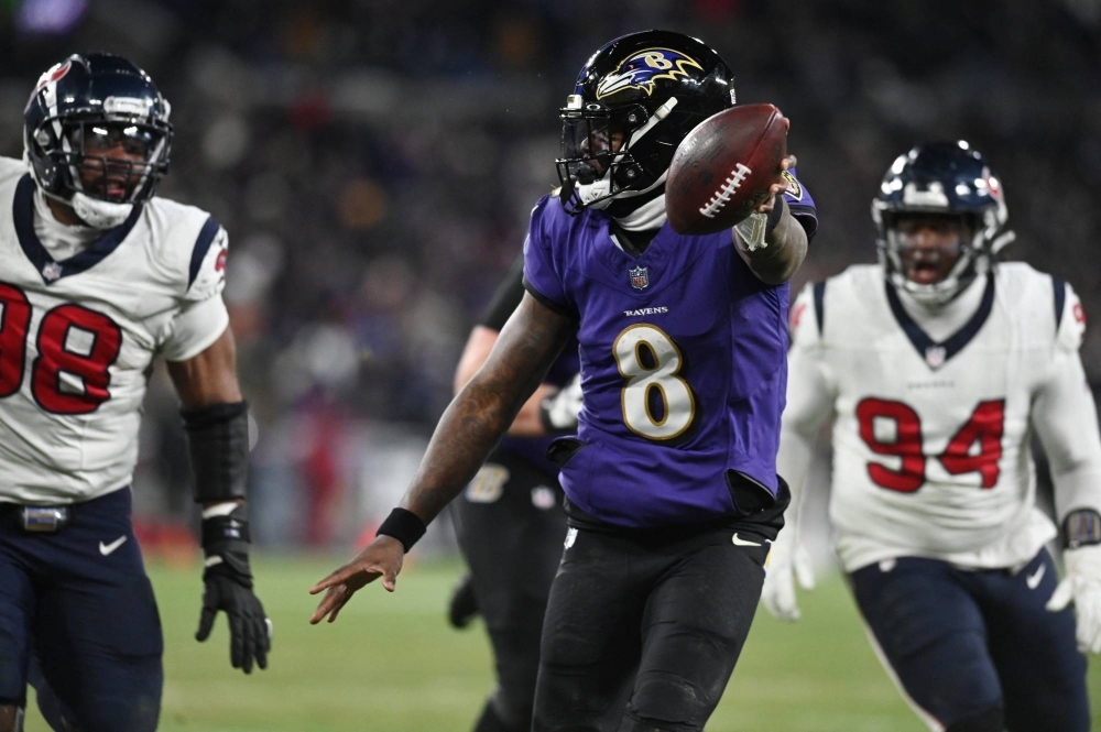 Ravens quarterback Lamar Jackson rushes in for a touchdown during Baltimore's playoff win over Houston on Saturday. 
