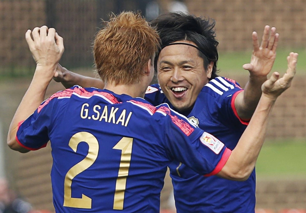 Yasuhito Endo celebrates his goal with teammate Gotoku Sakai during an Asian Cup group match against Palestine in 2015. 