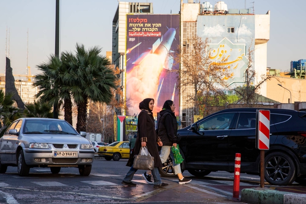 "Prepare your coffins," a banner warns Iran's adversaries in Tehran, on Jan. 16. After hitting targets in neighboring Pakistan, Iraq and Syria with missiles, Iran has played up not only its military capabilities but its determination to strike enemies at will. 
