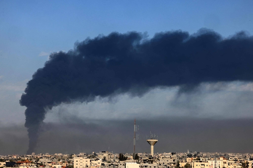 Smoke billows over Khan Yunis in the southern Gaza Strip during the Israeli bombardment on Sunday.