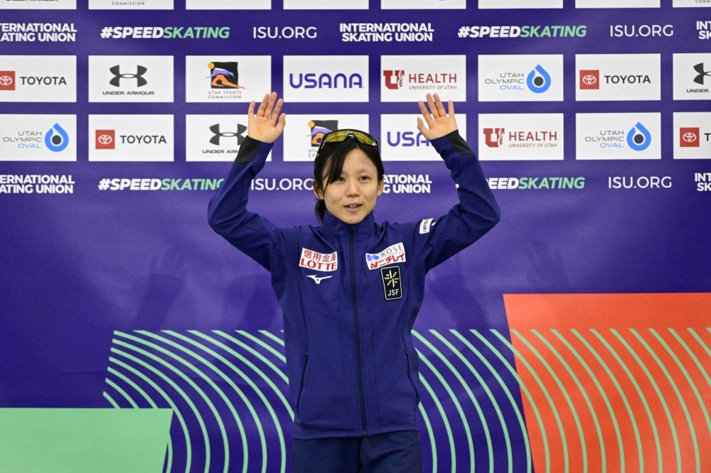 Miho Takagi stands on the podium after winning the women's 1,000-meter race at the Four Continents Speed Skating Championships in Salt Lake City on Sunday.