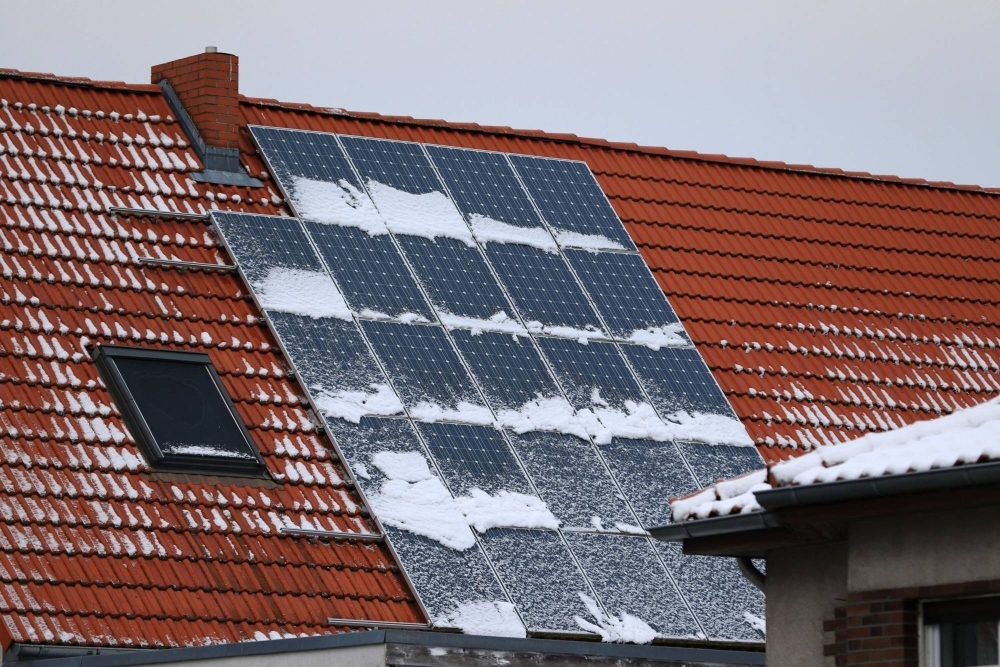 Snow collects on solar panels in a residential district of Berlin.