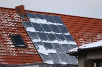 Snow collects on solar panels in a residential district of Berlin. | Bloomberg
