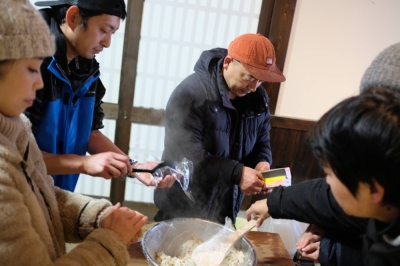 Toshiya Ikehata (center) helps prepare rice balls at a community kitchen in Wajima, Ishikawa Prefecture, on Jan. 7. Ikehata runs a fine-dining restaurant in the city, which was among the hardest-hit areas in the Noto Peninsula earthquake.