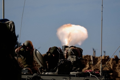 Israeli soldiers fire a mortar toward Gaza on Monday.