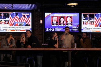 People drink as major news organizations project that Republican presidential candidate and former U.S. President Donald Trump wins during the New Hampshire presidential primary election, at The Goat in Manchester, New Hampshire, on Tuesday.