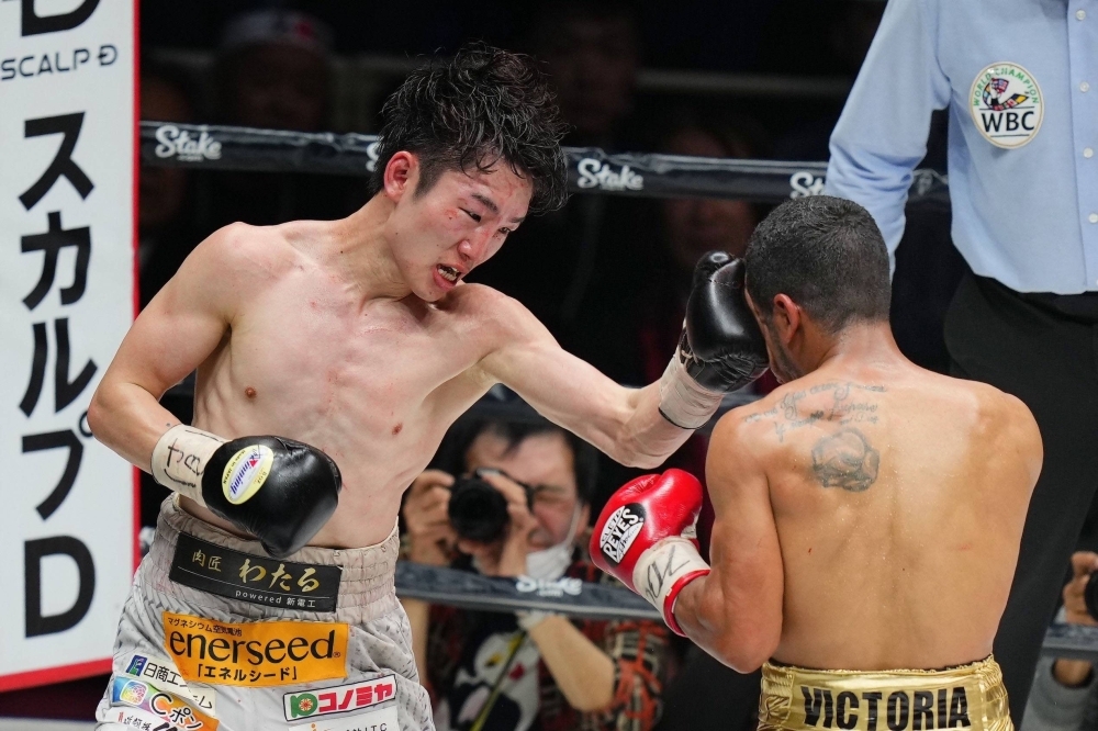 Kenshiro Teraji (left) throws a punch during his bout with Carlos Canizales on Tuesday at Edion Arena Osaka. 