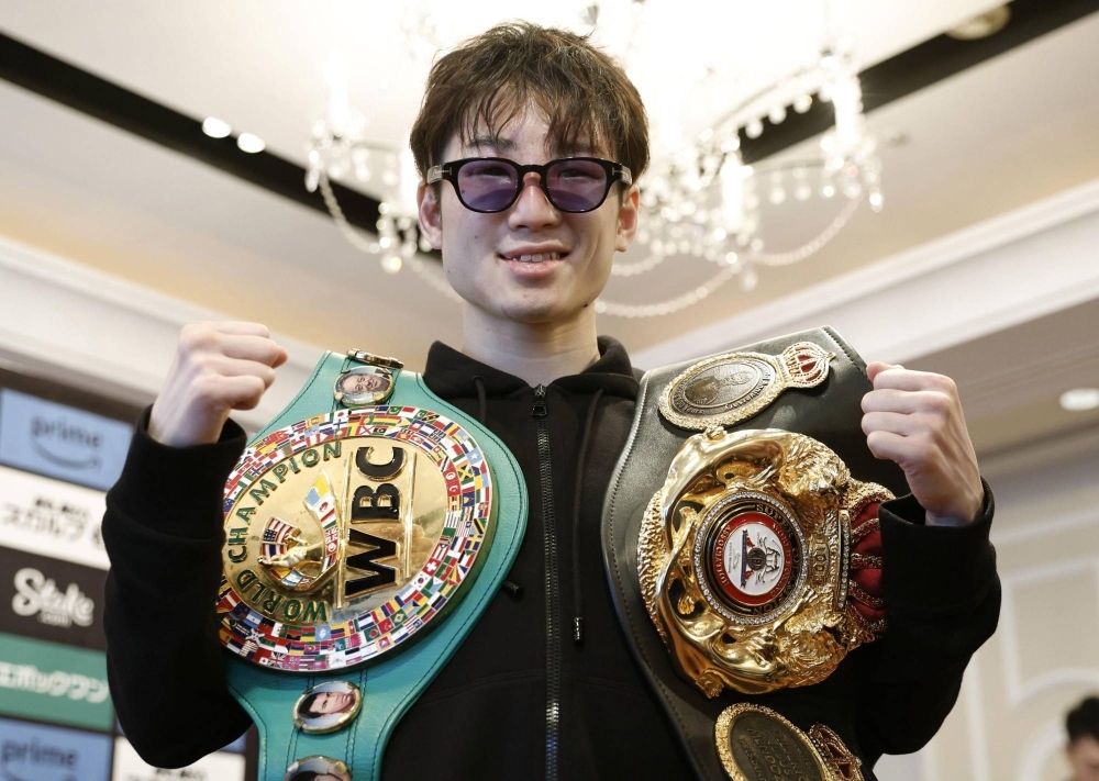 Teraji with his WBA and WBC light flyweight belts on Wednesday in Osaka