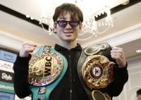 Teraji with his WBA and WBC light flyweight belts on Wednesday in Osaka | Kyodo 