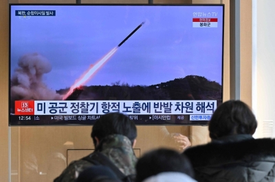 People watch a news broadcast with file footage of a North Korean missile test, at the main railway station in Seoul on Wednesday.