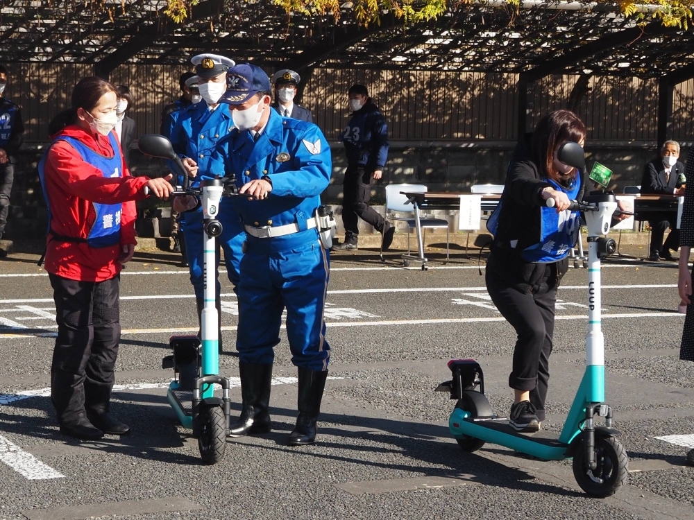 Police officers hold a traffic safety lesson for e-scooter users in December 2022 in Tokyo's Meguro Ward.
