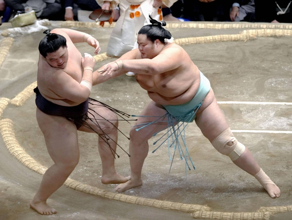 Kotonowaka (right), defeats Oho at the New Year Grand Sumo Tournament in Tokyo on Wednesday.