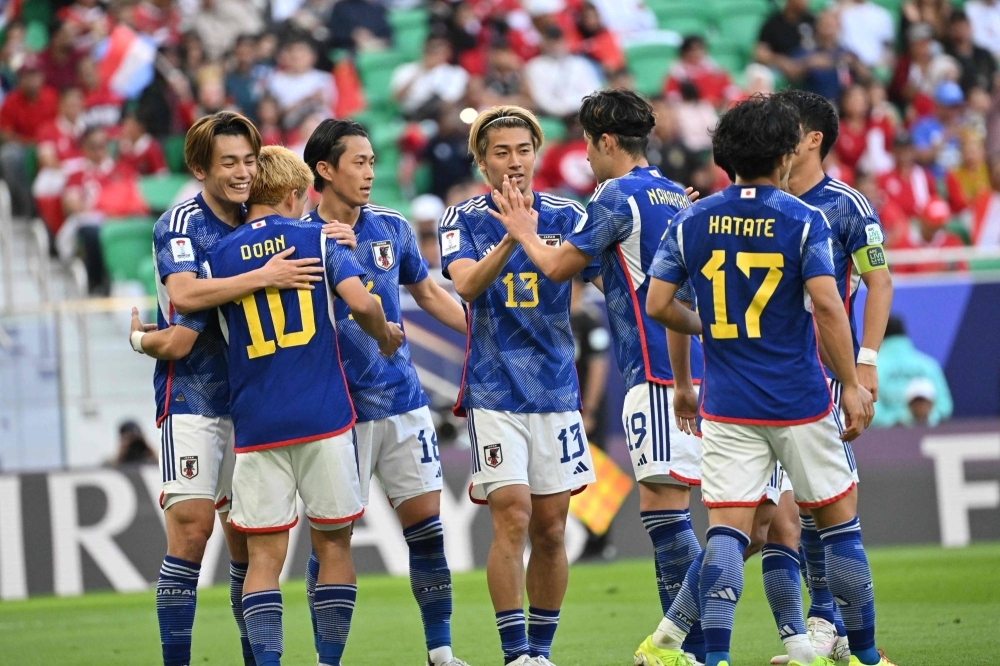 Japan players celebrate after Ayase Ueda scored the team's second goal during Samurai Blue's win over Indonesia on Wednesday. 