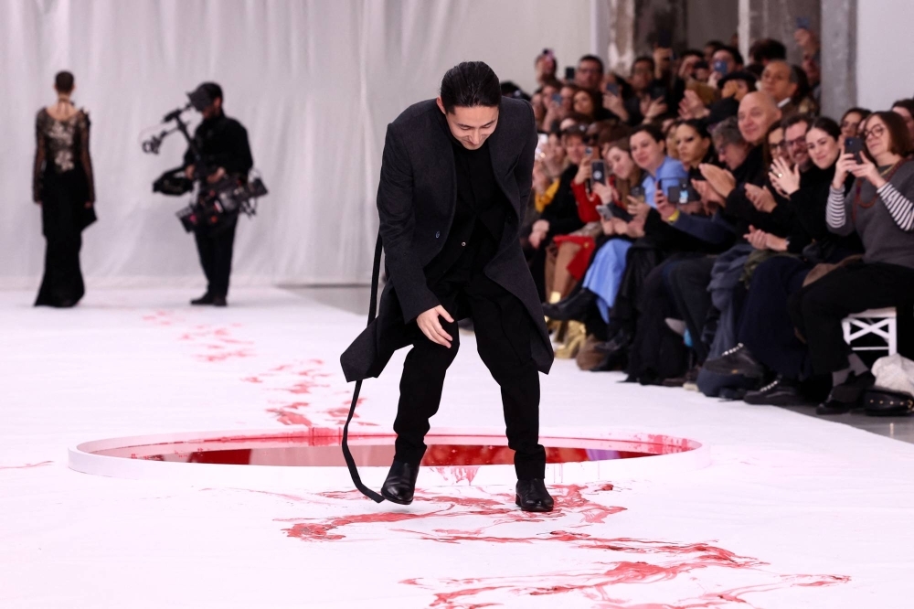 Designer Yuima Nakazato appears at the end of his haute couture Spring-Summer 2024 collection show in Paris.