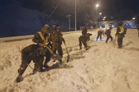 Ground Self-Defense Force members remove snow on a section of the Meishin Expressway in Gifu Prefecture on Wednesday. | Defense Ministry / via Kyodo