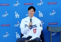 Shohei Ohtani speaks during his introductory news conference with the Dodgers at Dodger Stadium on Dec. 14, 2023. | REUTERS