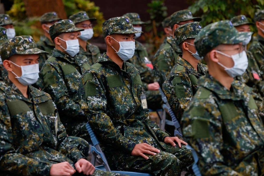 The first batch of new recruits listen to instructions as they prepare to begin one-year compulsory military service in Taiwan, after the previous four-month conscription period was extended, in Taichung, Taiwan, on Thursday.