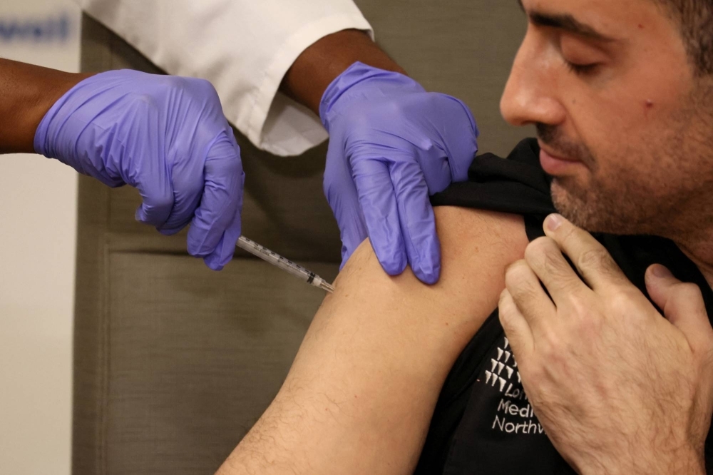A man is inoculated with a COVID-19 vaccine in New Hyde Park, New York, in September 2023.