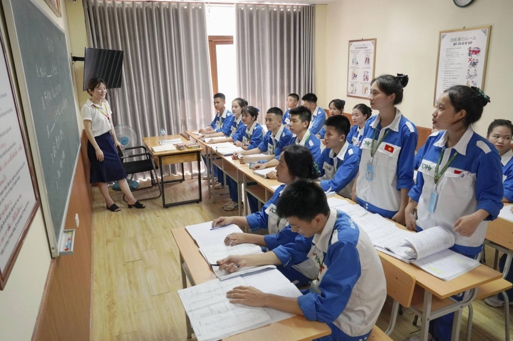Vietnamese people take Japanese lessons in Hanoi in June 2023 before heading to Japan to work.