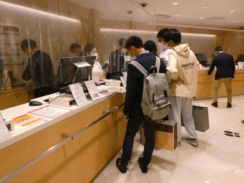 Foreign tourists at a duty-free counter in a department store in Tokyo