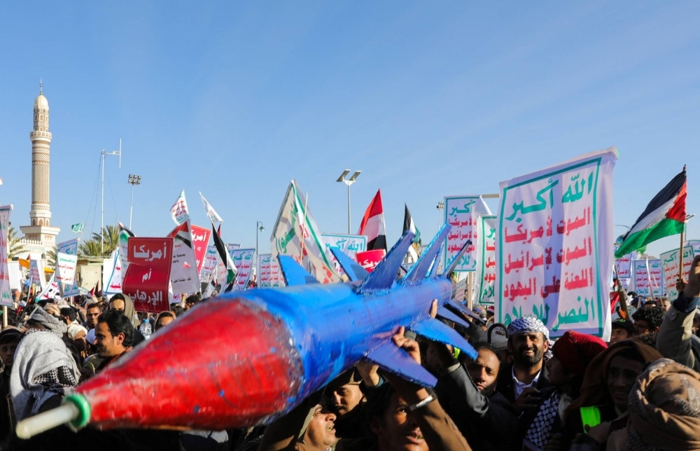 People supporting Houthi rebels carry a mock missile as they protest during a rally against the U.S.-led strikes on Houthi targets and continued Israeli strikes in the Gaza Strip, in Sana'a, Yemen, on Friday.