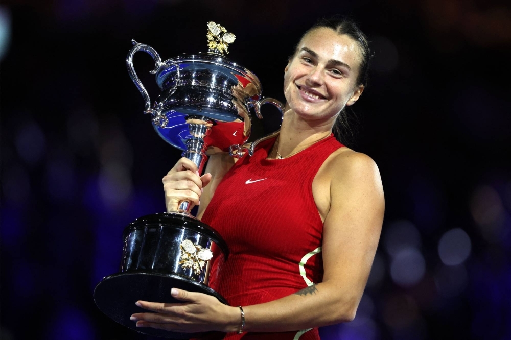 Aryna Sabalenka celebrates with the trophy after winning her second-straight Australian Open women's singles title on Saturday in Melbourne. 