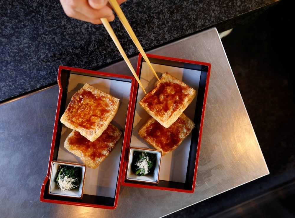 A chef prepares a tofu-based dish in Tokyo. Plant-rich and balanced diets that rely less on meat are not only healthy but also friendly to the planet.